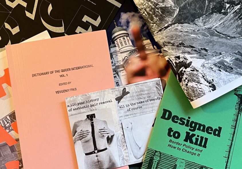 Photograph of a pile of printed zines.
