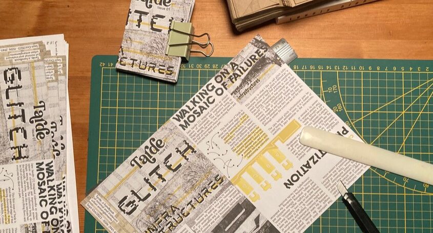Pages from a zine being folded.